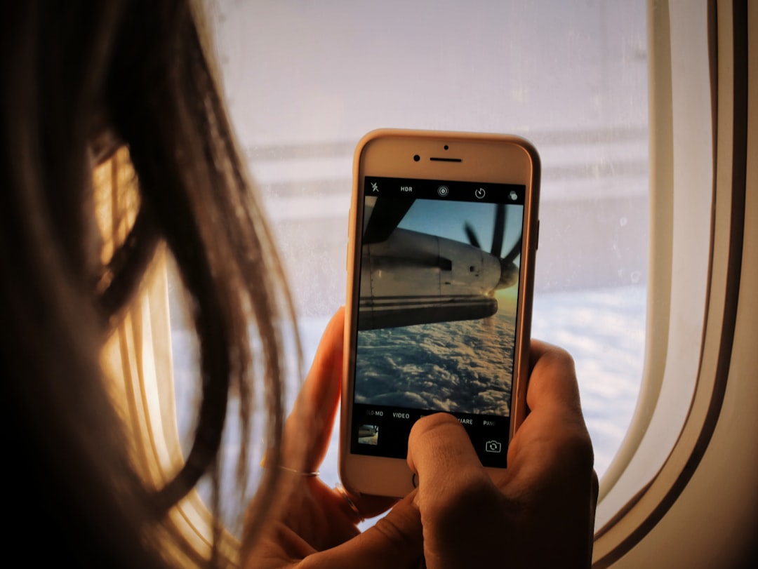 Person holding a phone while travelling, representing offline mobile work — Photo by Patrick Tomasso on Unsplash. Source: https://unsplash.com/photos/person-holding-phone-kVawprN_MPc